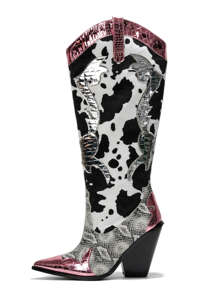 Tall cowboy boots with black and white cow print shaft, gray snakeskin textured lower portion, pointed toe with pink metallic cap, pink metallic trim along the collar, and silver metallic decorative accents resembling flames or wings on the sides, block heel