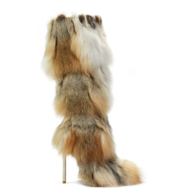 Detailed view of bold and fashionable boots featuring a pointed toe, stiletto heel, and a distinctive patchwork of faux fur in brown, beige, and white.