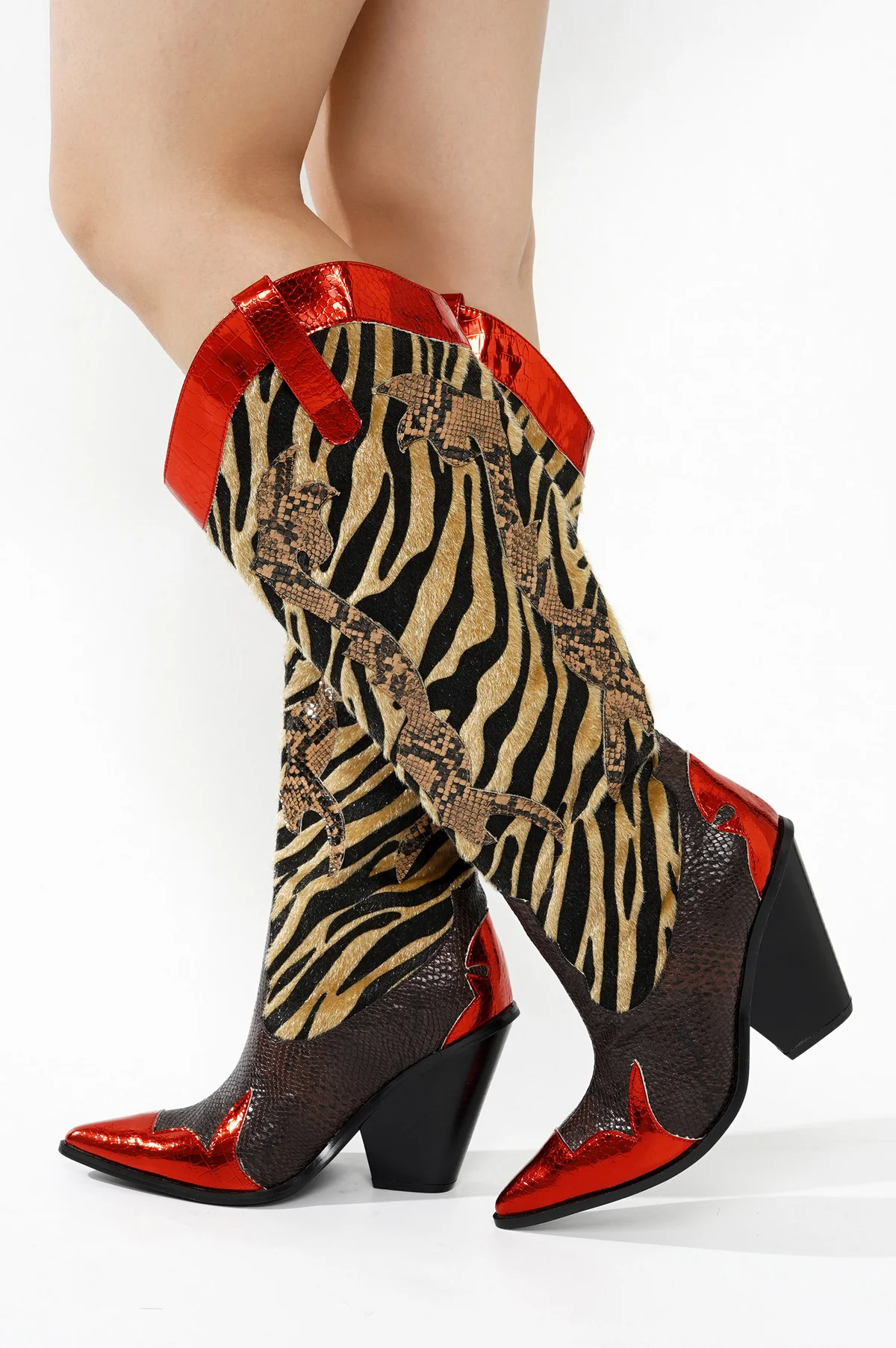 Mid-calf cowboy boots with brown textured vamp and heel, zebra print shaft, and snakeskin patterned side panels, red trim along the collar and seams, and block heel