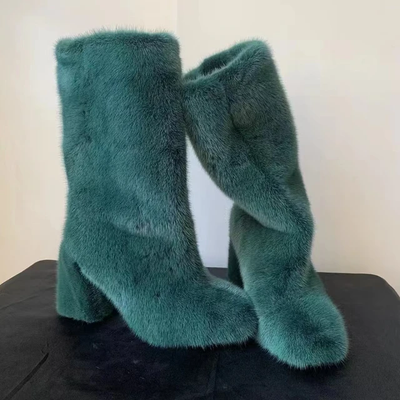 Elegant, knee-high winter boots crafted from plush, with teal mink fur 