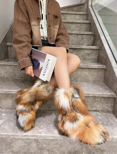 Eye-catching ankle boots crafted from plush, multicolored fox fur, perfect for making a statement in winter.