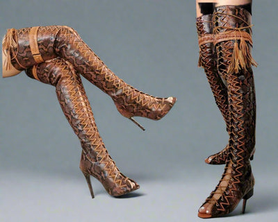 These statement-making over the knee boots combine a luxurious snake-embossed texture with a daring lace-up design and towering stiletto heels, creating a look that's both fierce and fashionable.