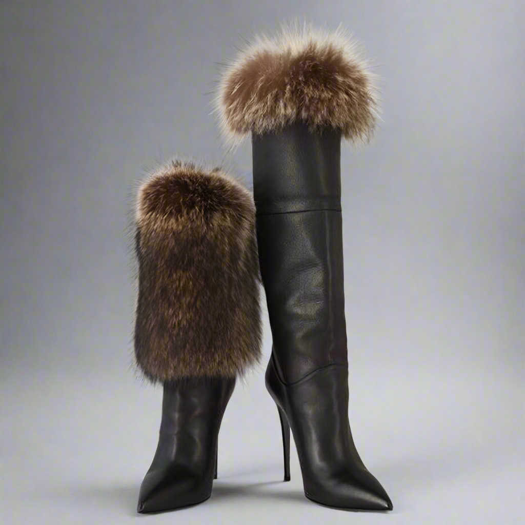 Stylish and versatile black winter boots crafted from smooth leather. The boots are shown with one boot fully extended to its knee-high length, while the other is cuffed down to showcase a shorter, more casual style. Both boots feature a luxurious-looking fur trim at the top, adding warmth and a touch of elegance.