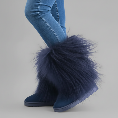 Blue furry boots worn with blue jeans on a gray background